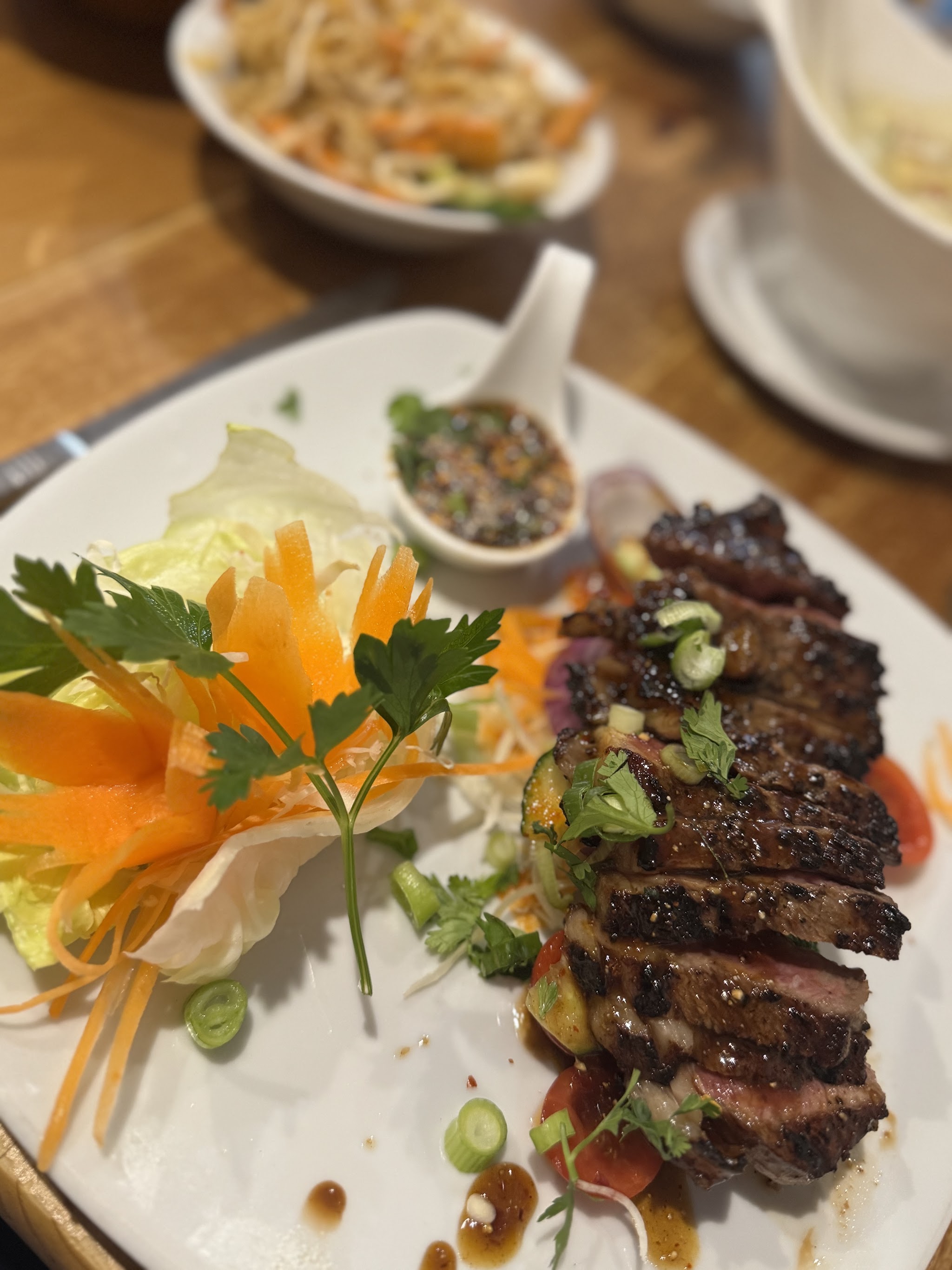 A beautifully presented dish on a white plate at Nam Jai Thai